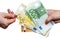 Female hand taking euro banknote from pile