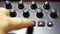 Female hand tunes midi synthesizer keyboard