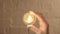 Female hand unscrews a light bulb. Woman unscrews a light bulb to light does not light