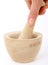Female hand using a mortar and pestle