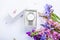 Female hand watch in gift box surrounded with flowers. Present for holiday. Flat lay