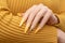 Female hand with yellow nail design. Long nail polish manicure. Woman manicure with gitter gold long nail art