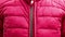 female hand zipper on red winter warm jacket, zipper on clothes