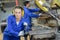 Female handling machinery in metal workshop