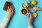 Female hands and alternative medicines on blue background, top view