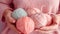 Female hands BEAUTIFUL close-up, knitting for a newborn, crochet.booties, top view on a soft pink blue beige background,tenderness