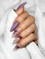 Female hands with beautiful colorful hybrid nails and professional manicure.