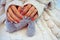 Female hands with beautiful design of nails hold a toy on a knit