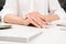 Female hands with beautiful manicure holding pen at workplace