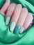 Female hands beautiful manicure, stylish texture, gradient silk fabric