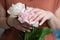 female hands with a beautiful peach manicure design, color 2024, pastel colors, delicate spring dewy peonies