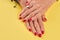 Female hands with beautiful red manicure.
