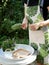 Female hands bind the fresh herbs into bouquets for drying.