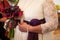 Female hands with a bouquet of burgundy flowers