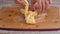 Female hands braiding a dough. Making yeast sweet buns with apricot jam.