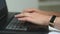 Female hands of a businesswoman professional user-an employee typing on a laptop keyboard, sitting at a table, a student