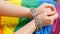 Female hands chained against the background of the LGBT flag. The concept of  the fight for tolerance and equal treatment of