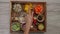 Female hands check ingredients served on tray ready to cook vegetable sauce from carrots, cashew nuts, yellow bell