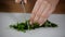 Female hands chopped parsley