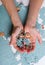 Female hands collect a heap of a broken puzzle on a white background. Organization of the process