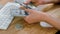 Female hands counting cash with bitcoins. Crop view of woman hands counting large bundle of dollar banknotes on wooden