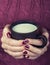 Female hands with a cup of warm milk