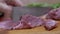 Female Hands Cuts Raw Pork Meat with a Sharp Knife on a Cutting Wood Board. 4K