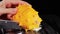 Female hands Cutting African horned melon, on black background