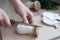 Female hands cutting fresh king oyster mushroom on cutting board in the kitchen, cooking at home concept