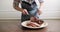 Female hands cutting freshly cooked hot meat on plate. Pork leg with spices garlic cooked in the oven