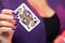 Female hands on the decollete background hold a deck of cards