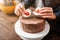 Female hands decorate cake with cookies