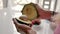 Female hands divide ripe avocado into two identical parts, natural light,closeup