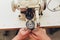 Female hands doing maintenance work on a domestic sewing machine.