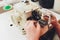 Female hands doing maintenance work on a domestic sewing machine.