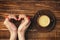 Female hands formed the heart and a cup of coffee beverage on th