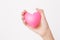 Female hands giving pink heart for love symbol sign on white background