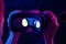 Female hands hold 3d 360 vr headset glasses in futuristic purple neon light