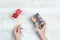 Female hands hold a gift box with rainbow LGBT ribbon nd pair of decorative lips on a light wooden table