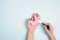 Female hands hold human stomach model and magnifier on blue background. Treatment of stomach diseases