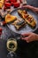 Female hands hold a plate with baked mackerel and bruschetta with cheese, fresh juicy tomatoes. White wine and seafood. Still life