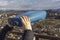 Female hands hold sightseeing touristic telescope. View from the observation deck viewing platform at the mountains landscape.