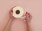 Female hands hold toilet paper on a colored background