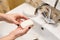 Female hands holding bar of soap, starting washing hands