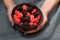 Female hands holding a bowl full of blackberries and raspberries