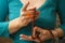 Female hands holding buddhist mala rosary with rudraksha beads