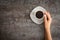 Female hands holding coffee cup over dark table