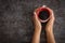 Female hands holding coffee cup over dark table