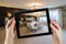 Female Hands Holding Computer Tablet In Room with Photo on Screen