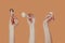 Female hands holding cream beige mushrooms in different angles and positions with copy space